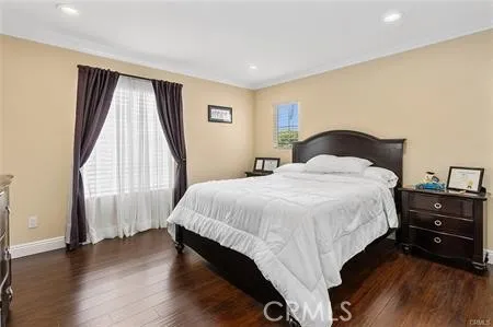 a bedroom with a bed and a large window