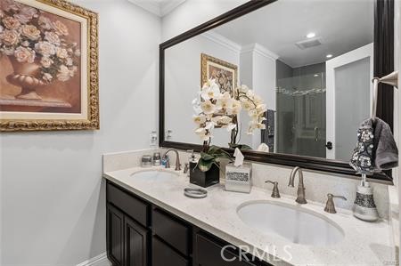 25724 Lewis Way Stevenson Ranch, CA 91381 - Photo 27 of 36 a bathroom with a double vanity sink and a mirror