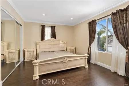 a bedroom with a bed and a large window