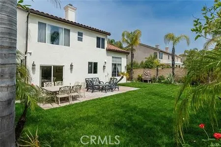 a view of house with a backyard