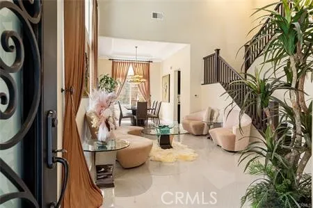 a living room with furniture and a floor to ceiling window