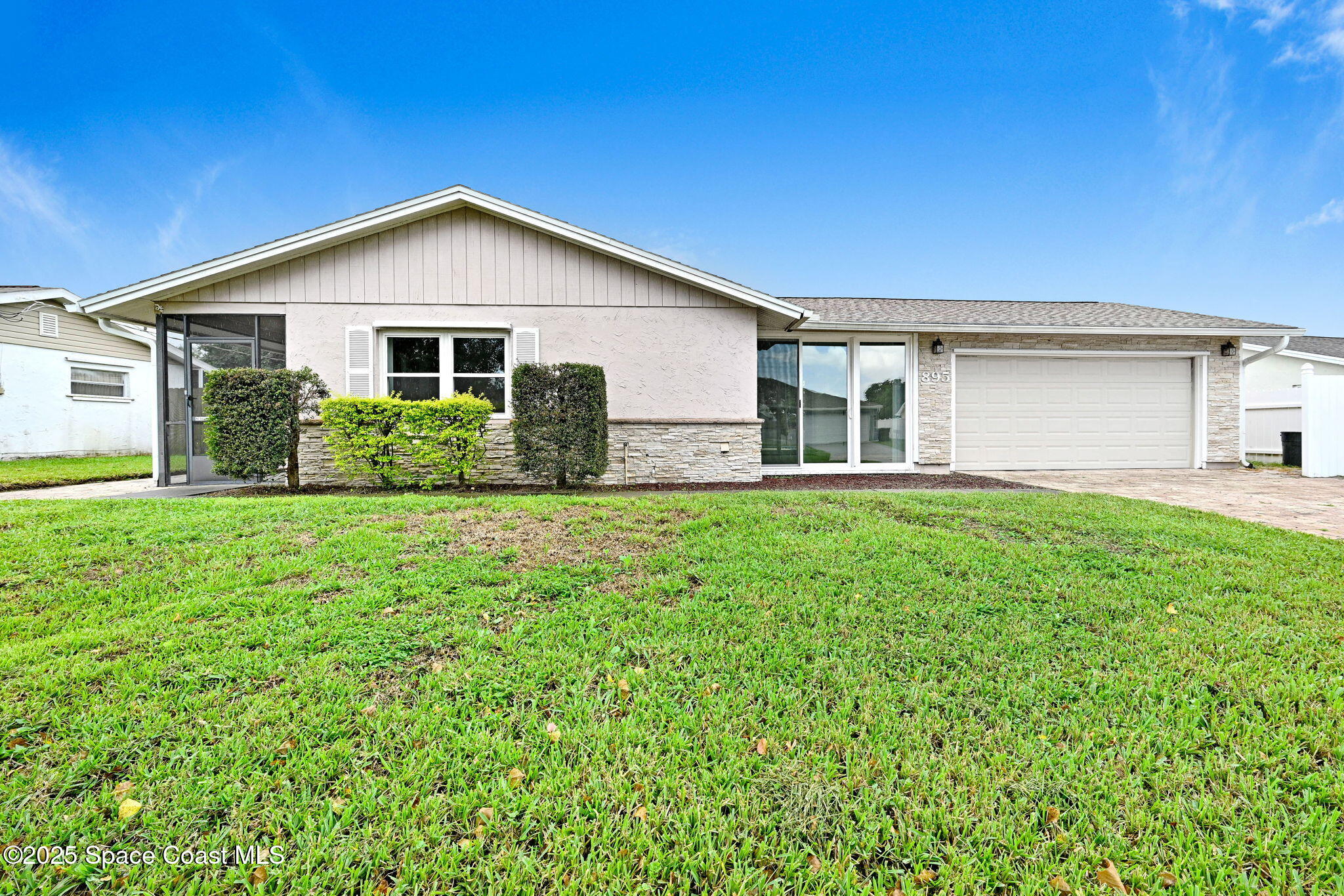 a front view of house with yard and green space