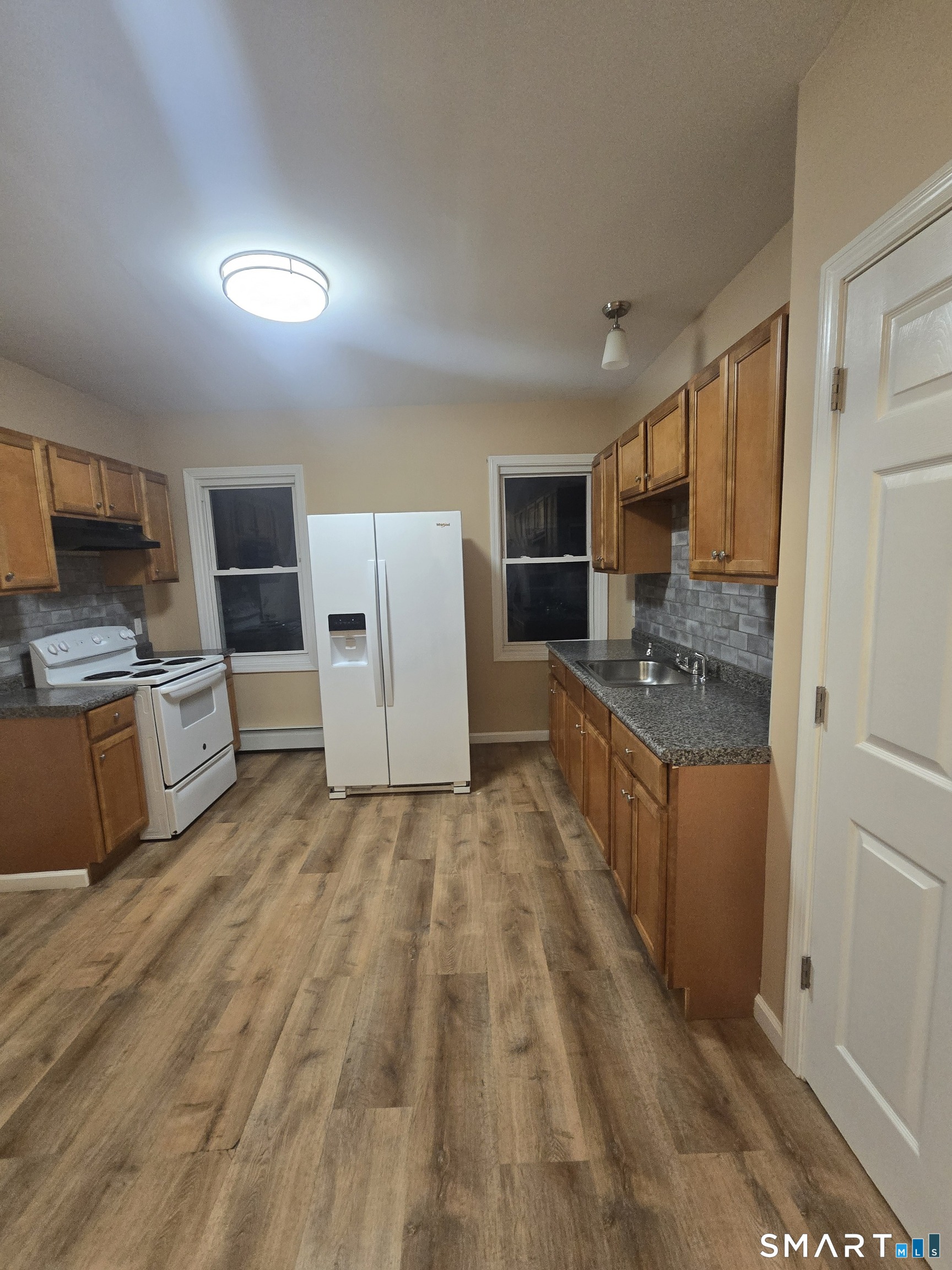 38 Burton Street Hartford, CT 06112 - Photo 11 of 18 a large white kitchen with cabinets