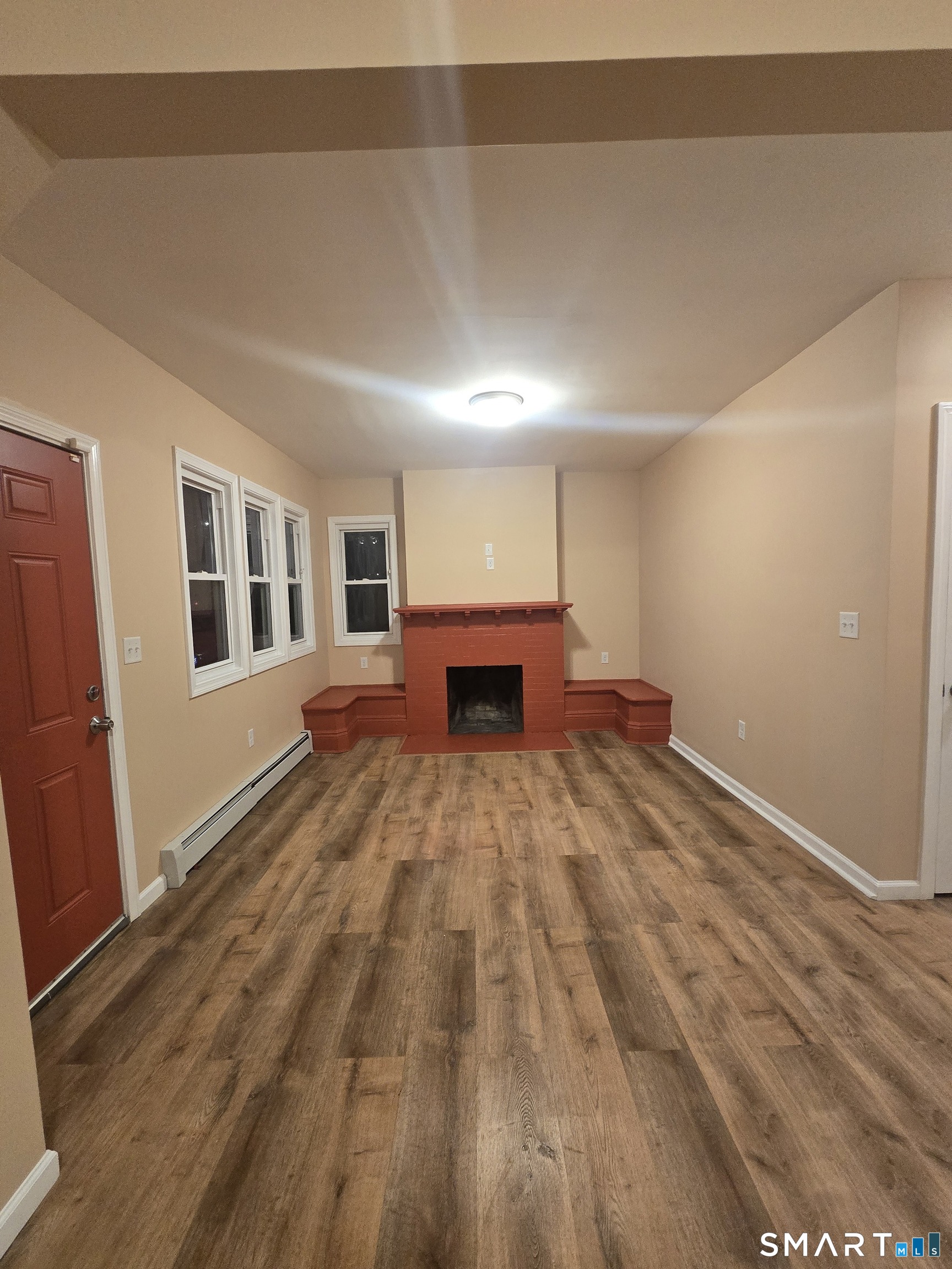 38 Burton Street Hartford, CT 06112 - Photo 3 of 18 a view of empty room with wooden floor and fireplace