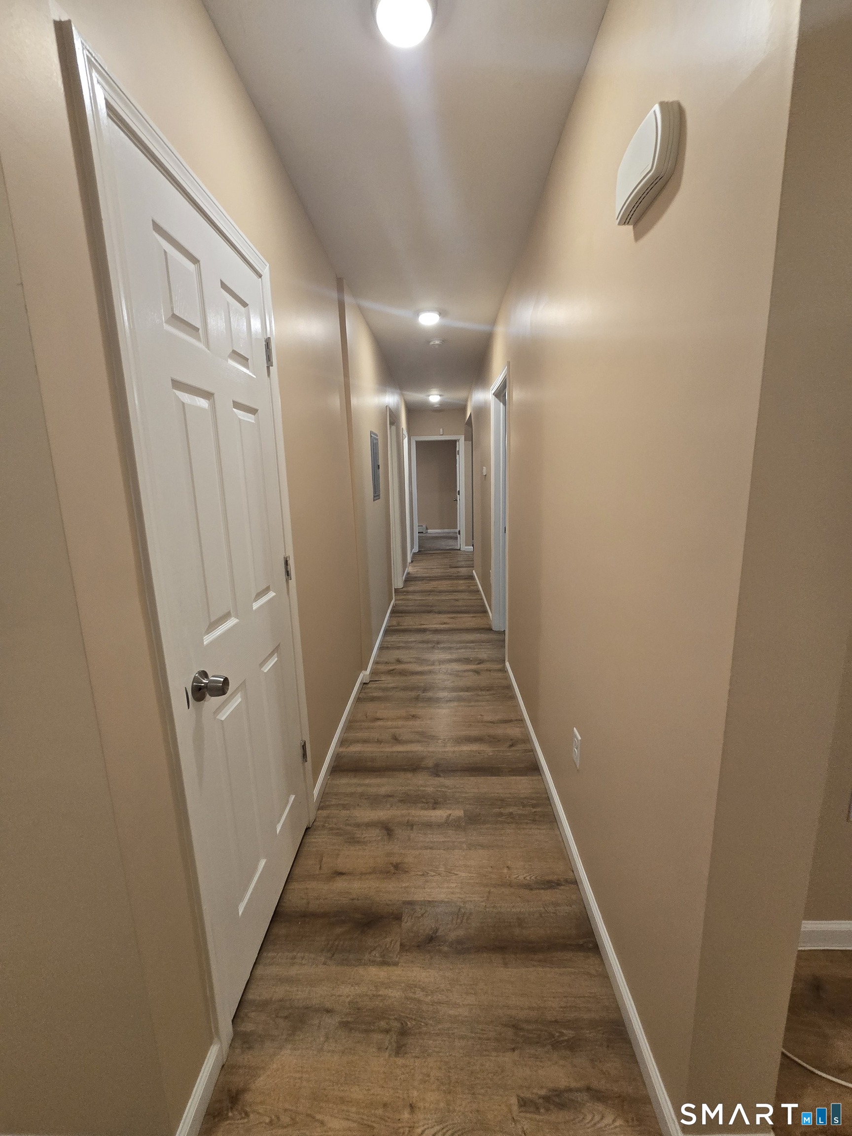 38 Burton Street Hartford, CT 06112 - Photo 4 of 18 a view of a hallway with wooden floor and stairs