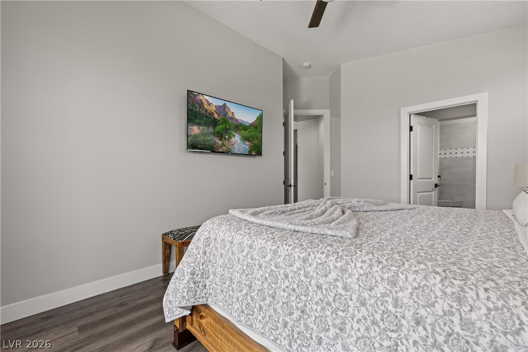 1436 Manassas Ridge Mesquite, NV 89027 - Photo 36 of 77 Relax in comfort with a large television, ceiling fan, and access to a full bathroom.