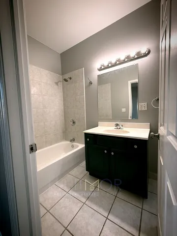 a bathroom with a sink mirror and a bathtub