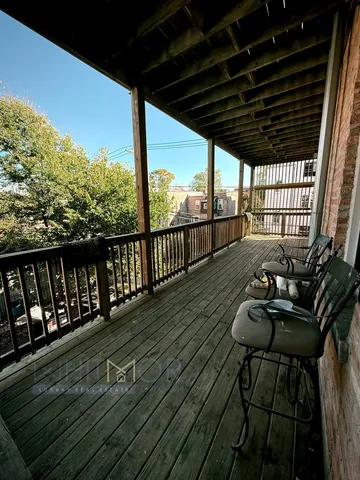 a view of balcony with wooden floor
