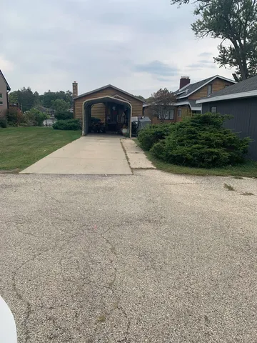 a view of a house with a yard and a garage