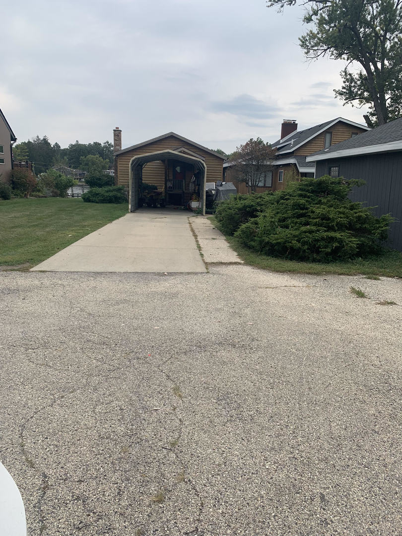 1107 Spring Beach Way Cary, IL 60013 - Photo 1 of 1 a view of a house with a yard and a garage