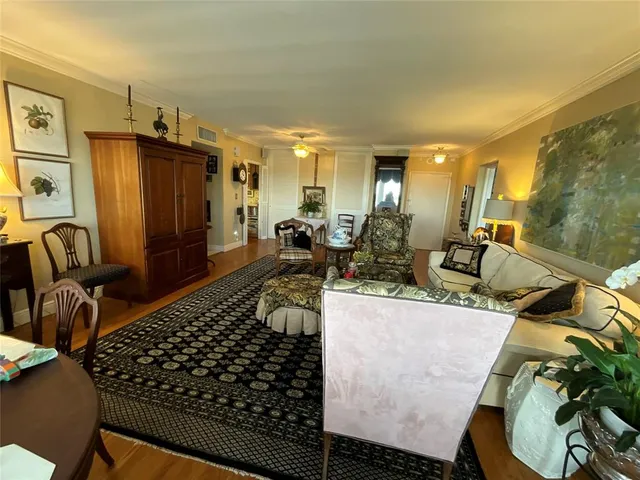 a living room with furniture fireplace and a large window