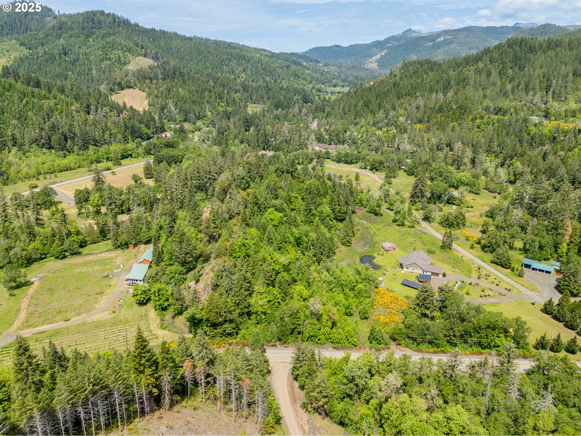400 Newbridge Road Glide, OR 97443 - Photo 11 of 15 a view of a lush green field with a houses