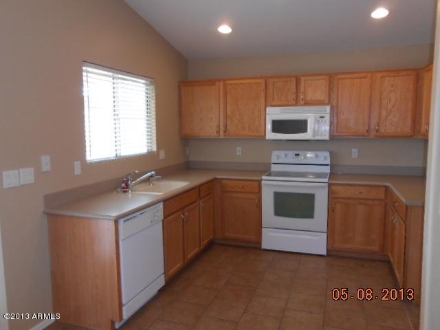 14744 West Calavar Road Surprise, AZ 85379 - Photo 5 of 15 a kitchen with a sink stove and microwave