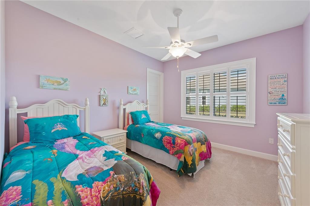 6391 Warwick Avenue Naples, FL 34113 - Photo 13 of 26 a bedroom with a bed mirror and a window