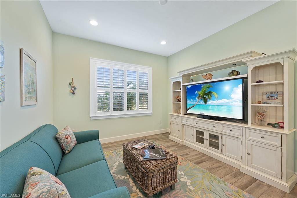 6391 Warwick Avenue Naples, FL 34113 - Photo 14 of 26 a living room with furniture and a flat screen tv