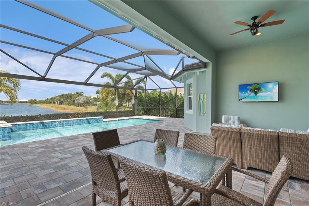 6391 Warwick Avenue Naples, FL 34113 - Photo 16 of 26 a dining room with furniture and a floor to ceiling window