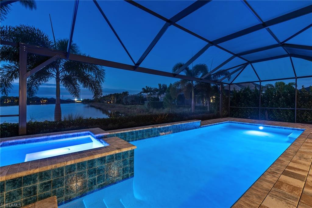 6391 Warwick Avenue Naples, FL 34113 - Photo 20 of 26 a view of swimming pool with a table and chairs under an umbrella
