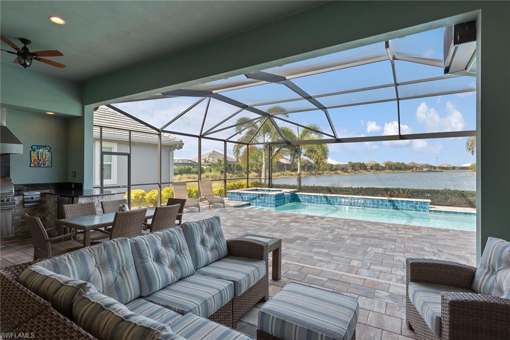 6391 Warwick Avenue Naples, FL 34113 - Photo 2 of 26 a outdoor living space with furniture and flat screen tv