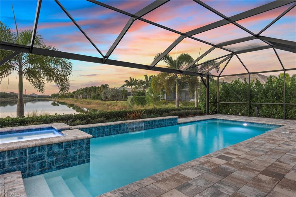 6391 Warwick Avenue Naples, FL 34113 - Photo 22 of 26 a view of a swimming pool with a yard