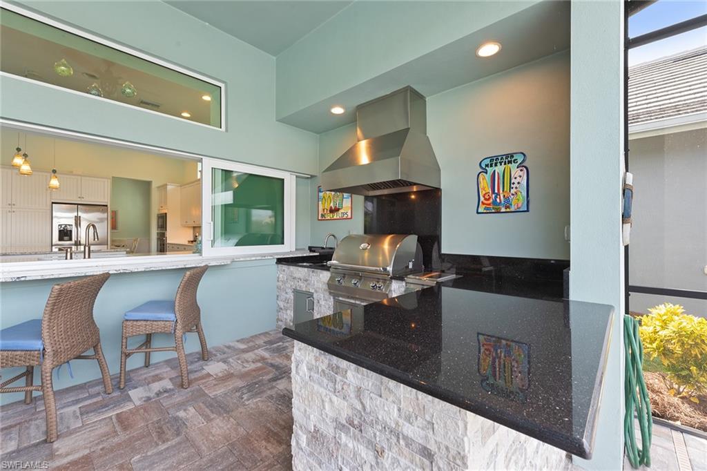 6391 Warwick Avenue Naples, FL 34113 - Photo 23 of 26 a living room with furniture a rug and white walls