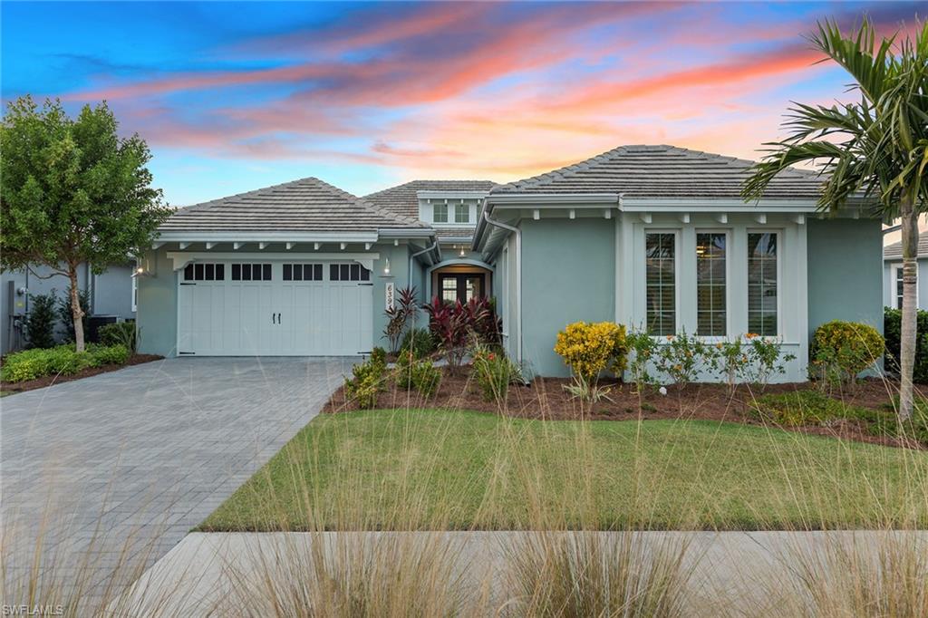 6391 Warwick Avenue Naples, FL 34113 - Photo 3 of 26 a front view of a house with a yard