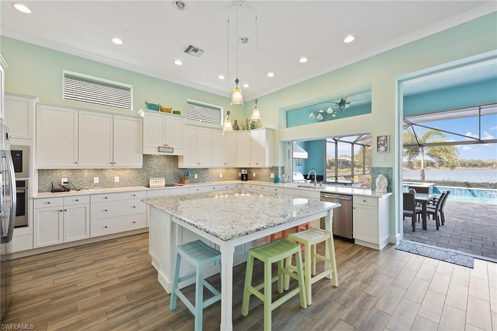 6391 Warwick Avenue Naples, FL 34113 - Photo 7 of 26 a kitchen with a table chairs sink and cabinets