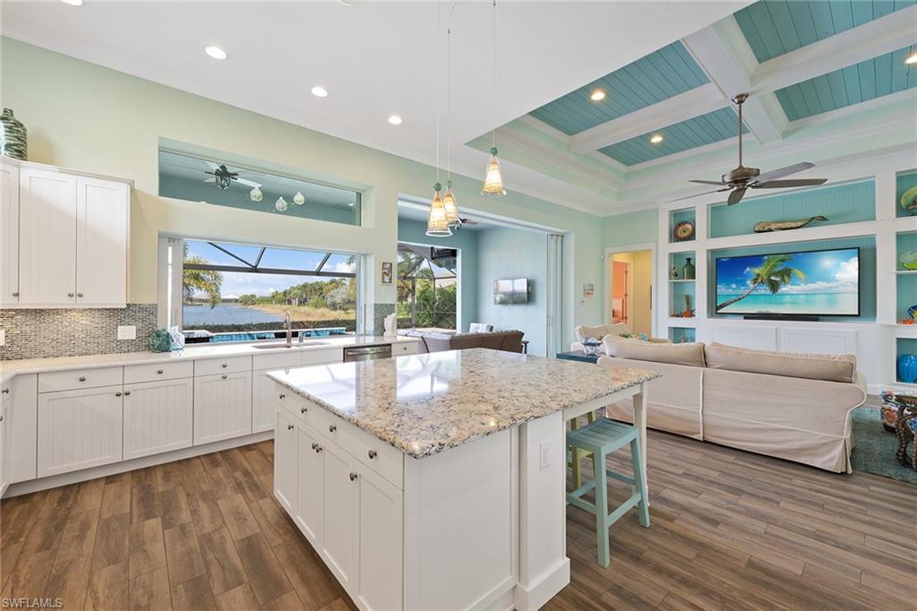 6391 Warwick Avenue Naples, FL 34113 - Photo 8 of 26 a kitchen with granite countertop white cabinets and white appliances