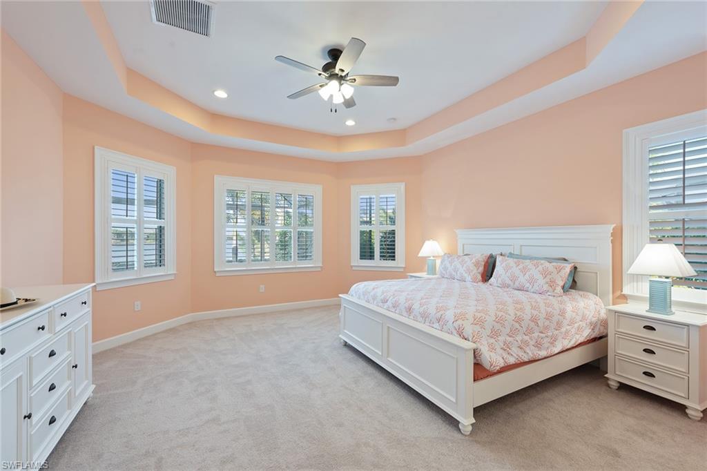 6391 Warwick Avenue Naples, FL 34113 - Photo 10 of 26 a spacious bedroom with a large bed and a window