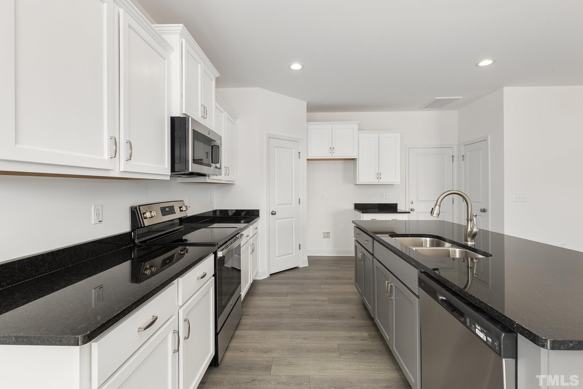 29 Bonnybrook Selma, NC 27576 - Photo 14 of 28 a kitchen with stainless steel appliances granite countertop a sink stove and cabinets