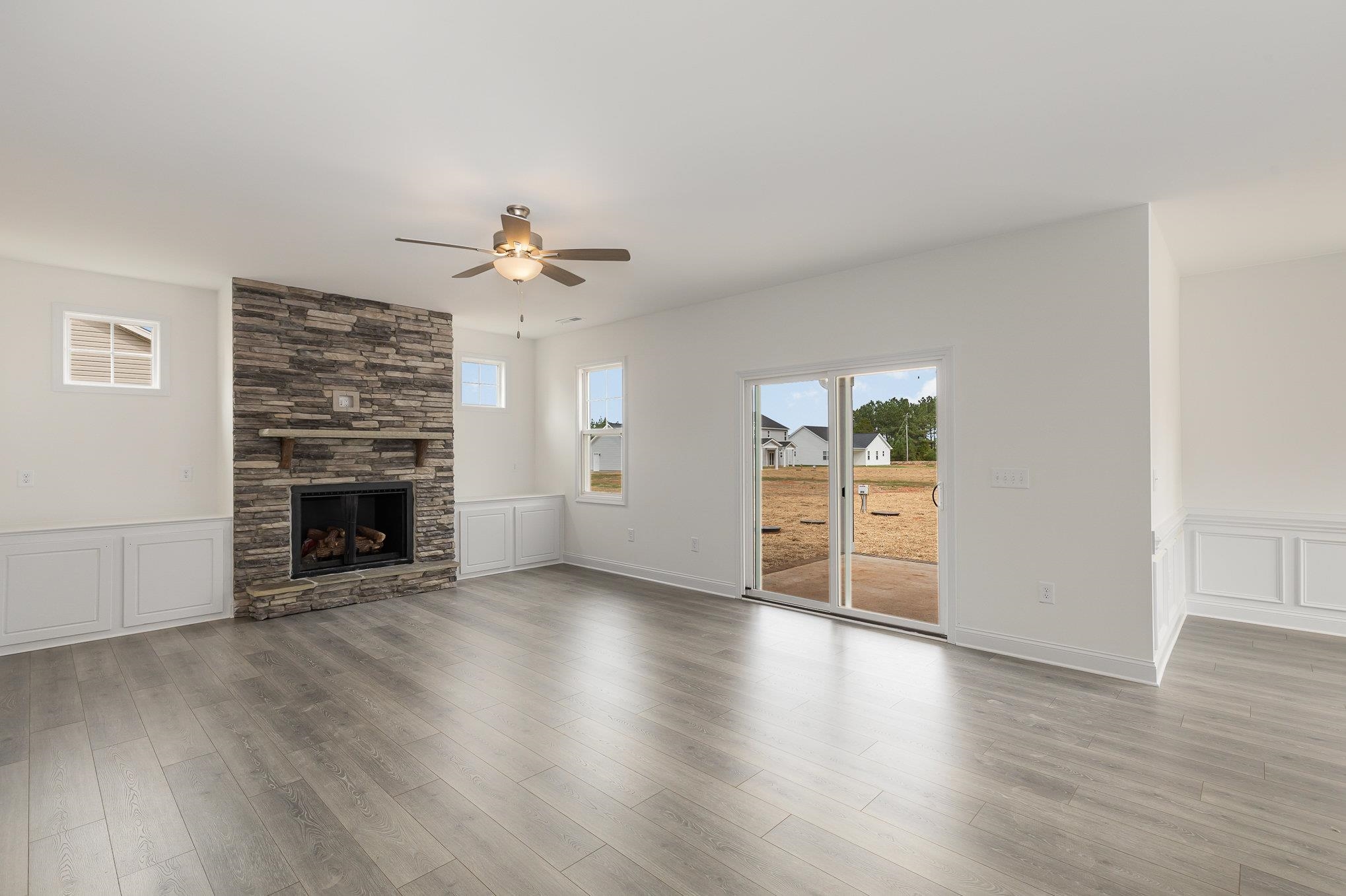 29 Bonnybrook Selma, NC 27576 - Photo 6 of 28 an empty room with wooden floor fireplace and windows