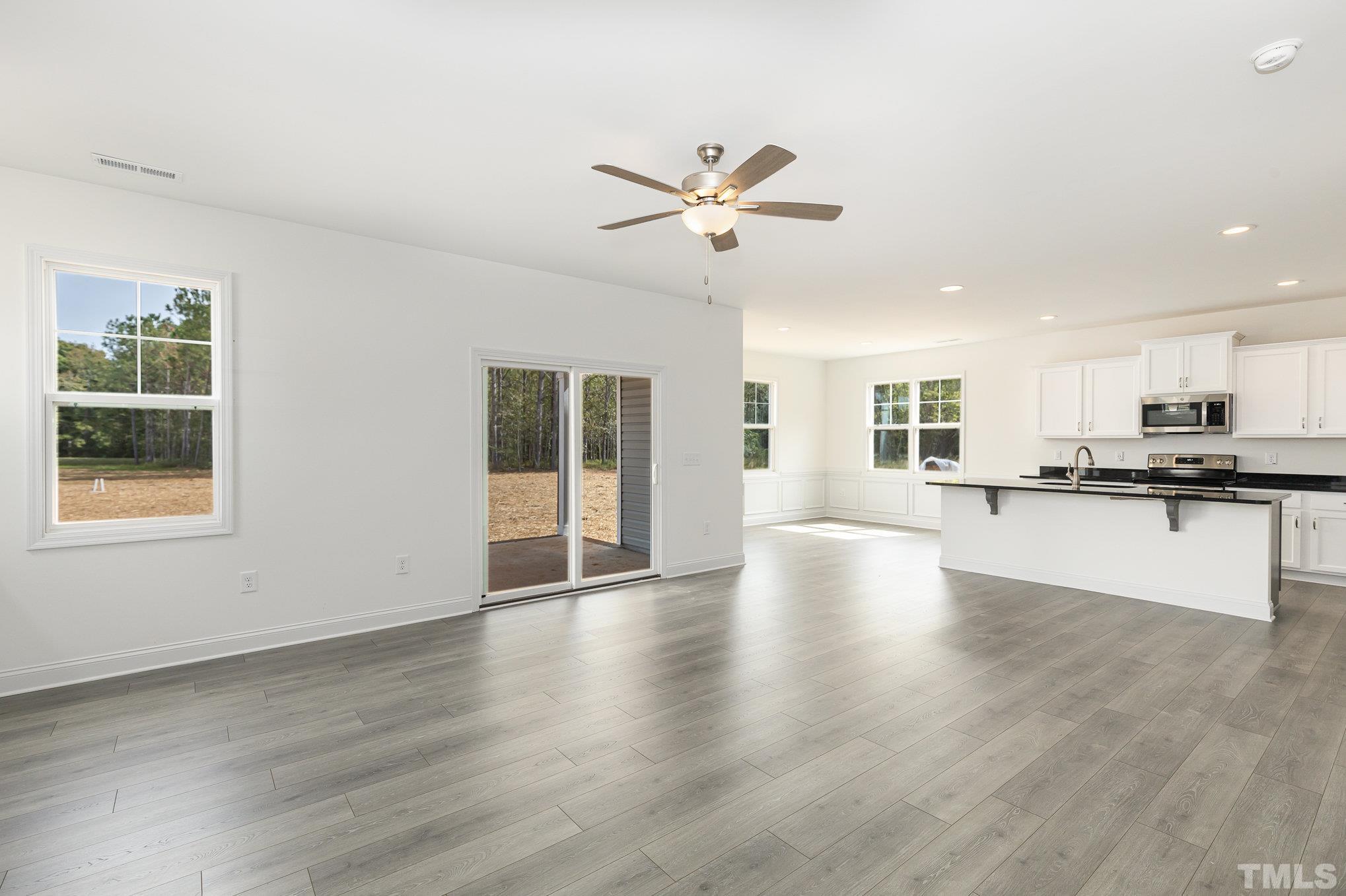 29 Bonnybrook Selma, NC 27576 - Photo 8 of 28 a view of an empty room with wooden floor and a kitchen
