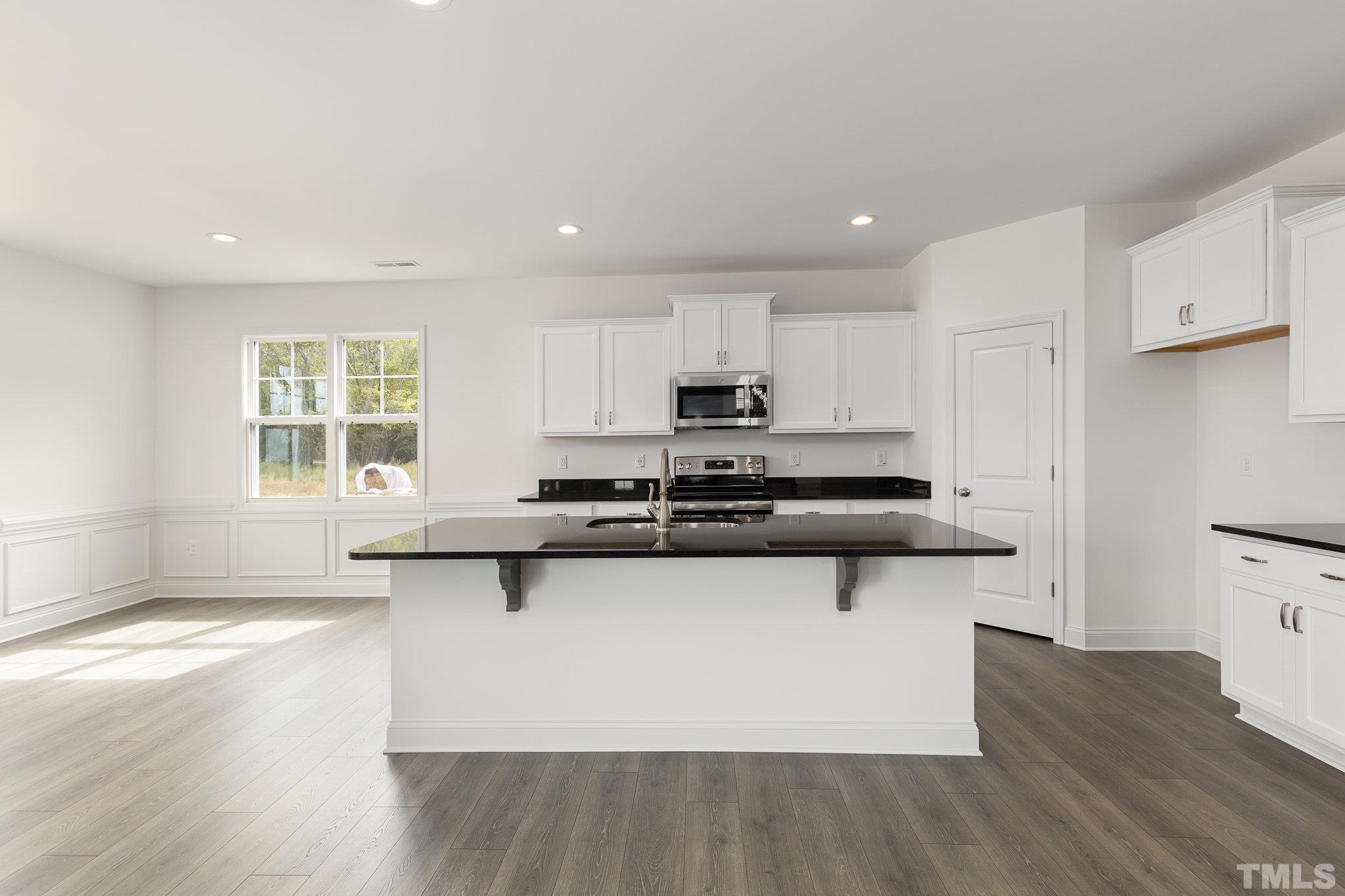 29 Bonnybrook Selma, NC 27576 - Photo 10 of 28 a kitchen with stainless steel appliances granite countertop a sink stove and wooden floor