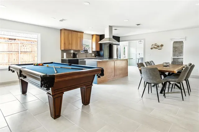 a view of a patio with a table and chairs