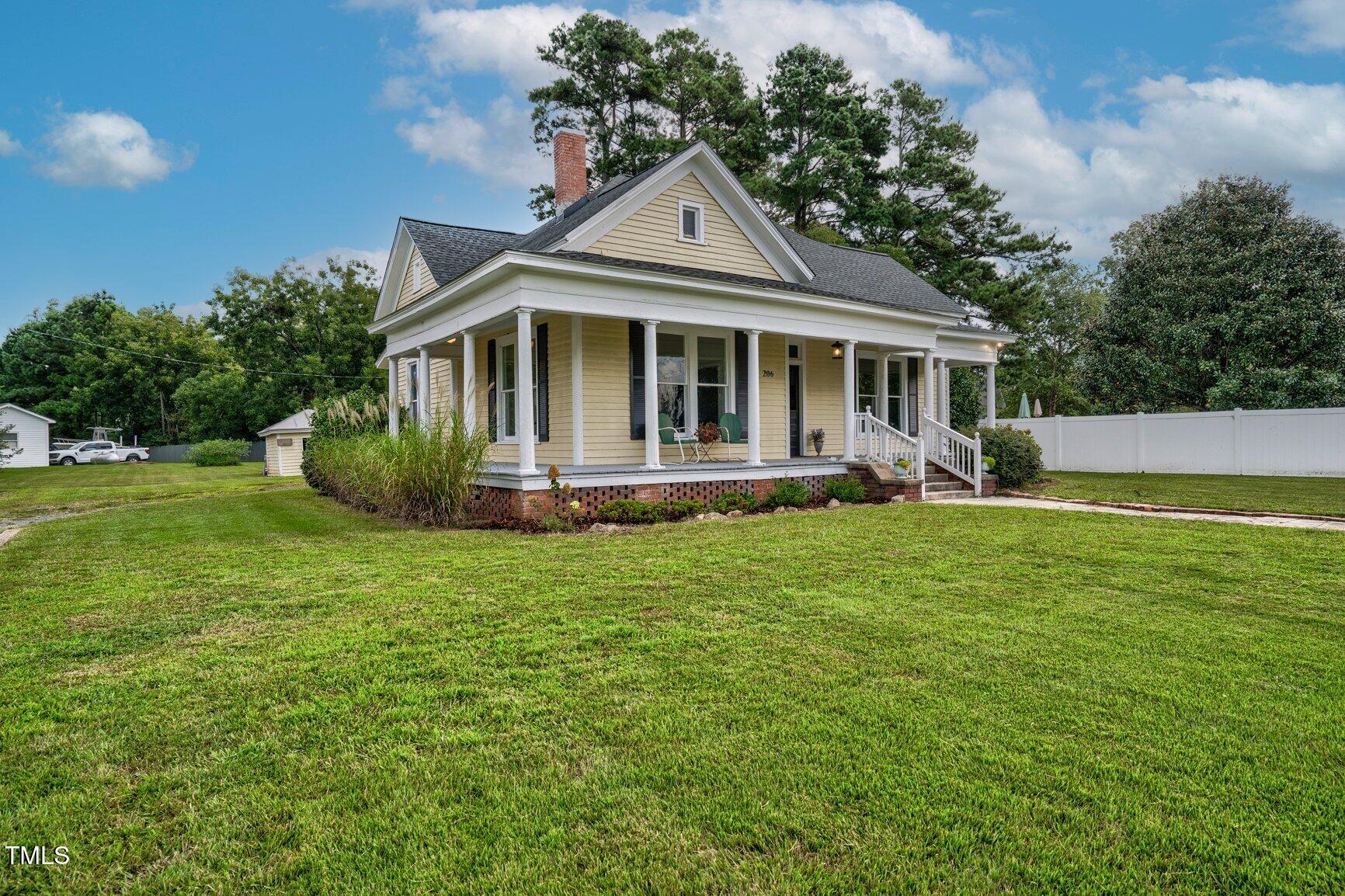 206 West Blalock Road Lucama, NC 27851 - Photo 2 of 35 a front view of a house with garden