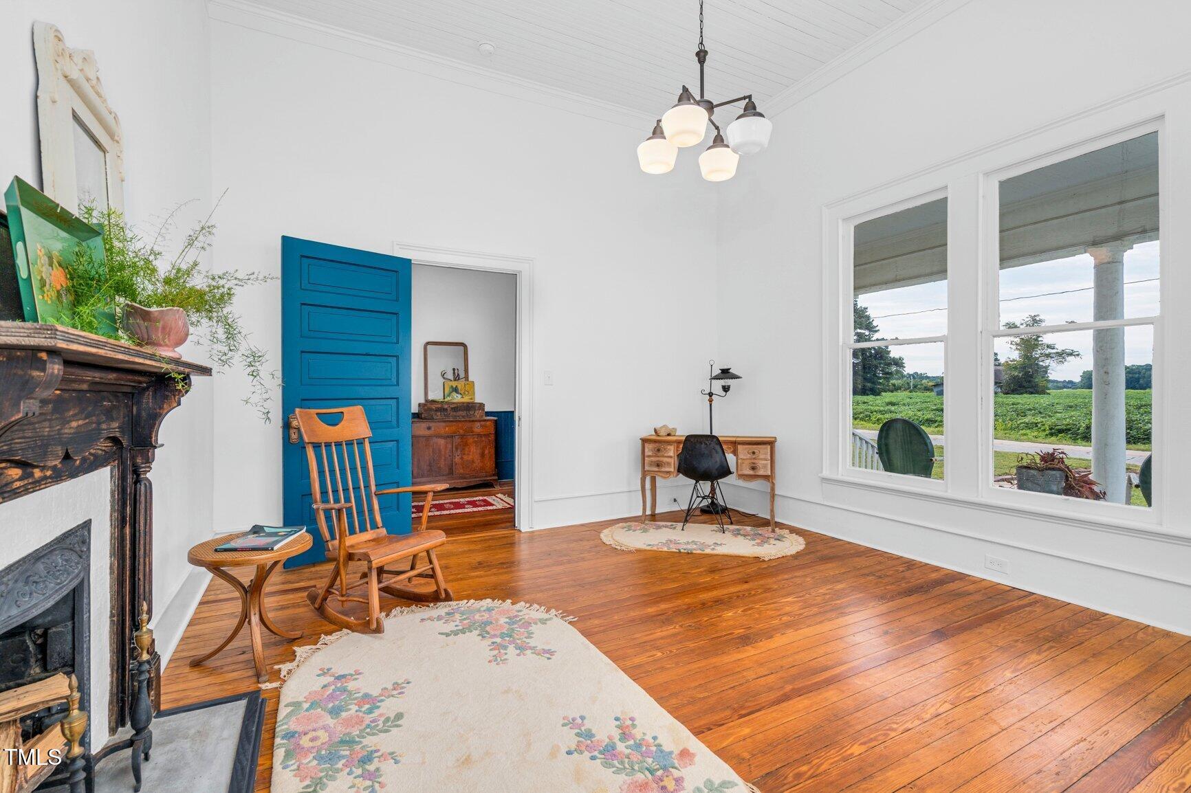 206 West Blalock Road Lucama, NC 27851 - Photo 26 of 35 a living room with furniture a fireplace and a potted plants