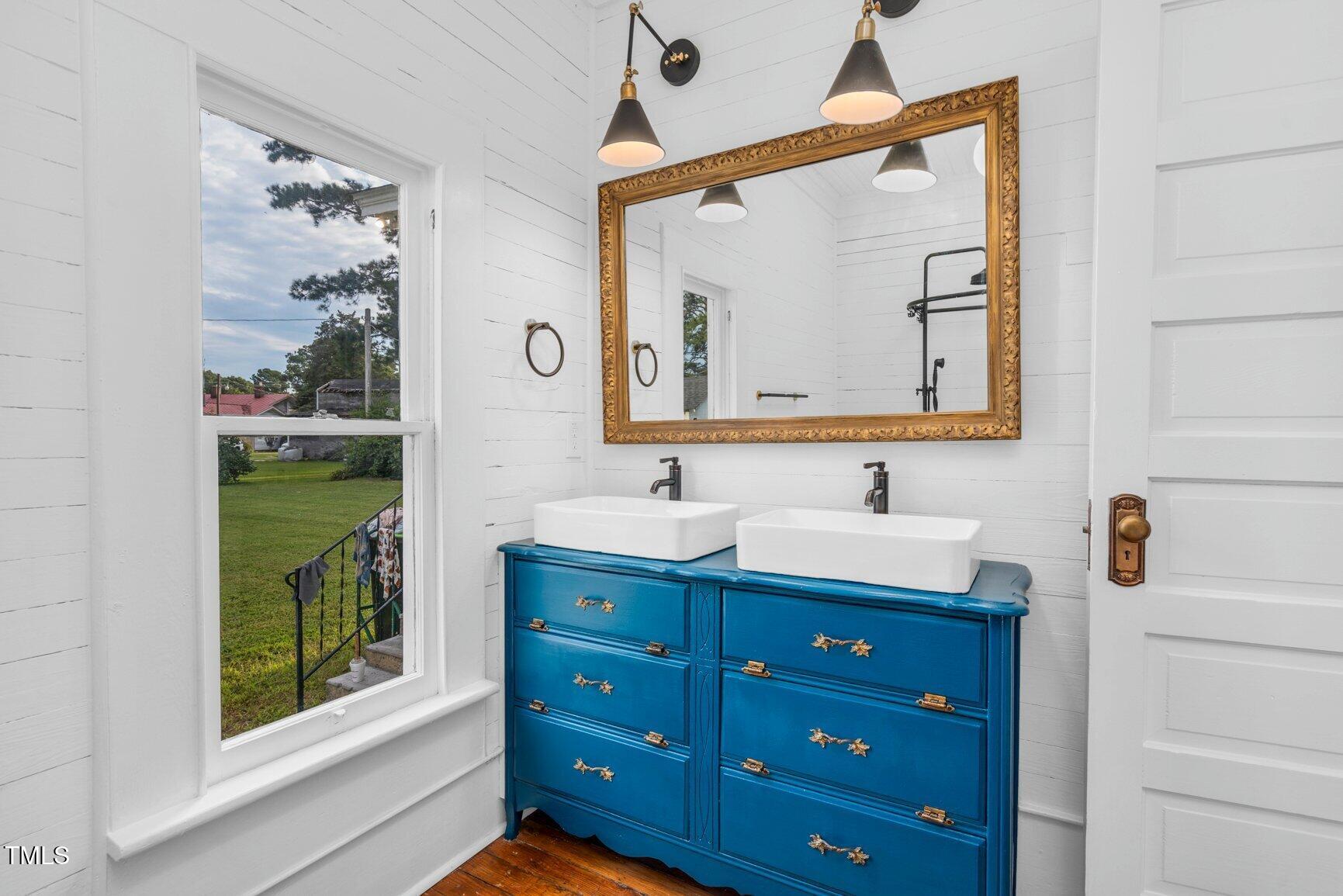206 West Blalock Road Lucama, NC 27851 - Photo 28 of 35 a bathroom with a double vanity sink and a mirror
