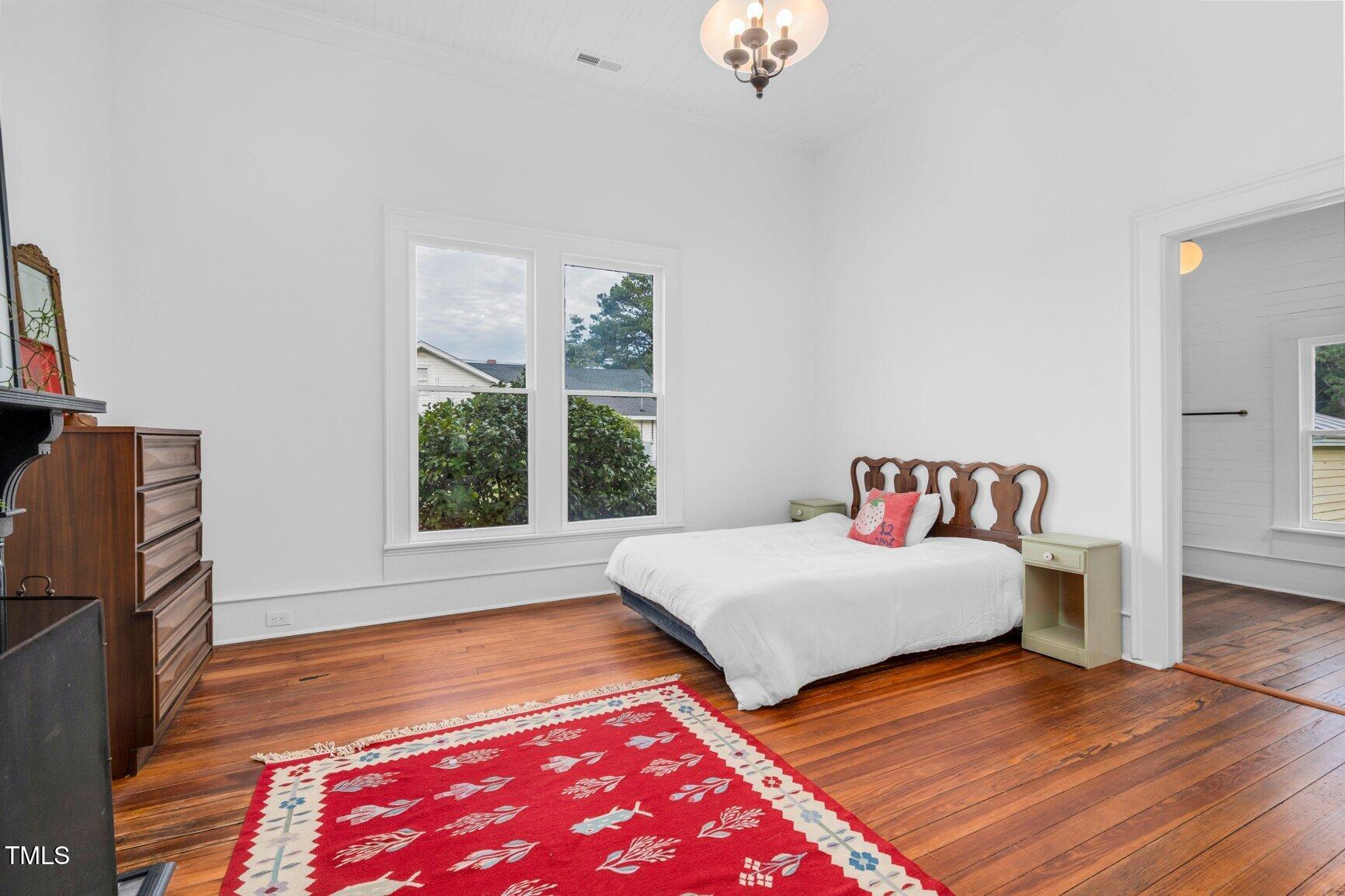 206 West Blalock Road Lucama, NC 27851 - Photo 29 of 35 a bedroom with natural light and wooden floor