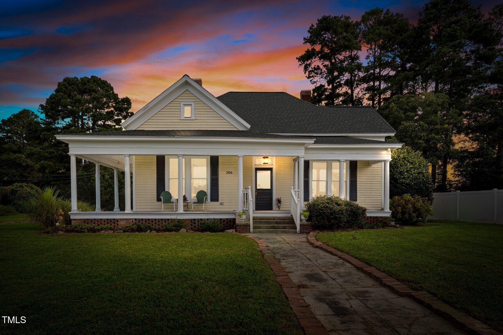 206 West Blalock Road Lucama, NC 27851 - Photo 3 of 35 a front view of a house with a yard