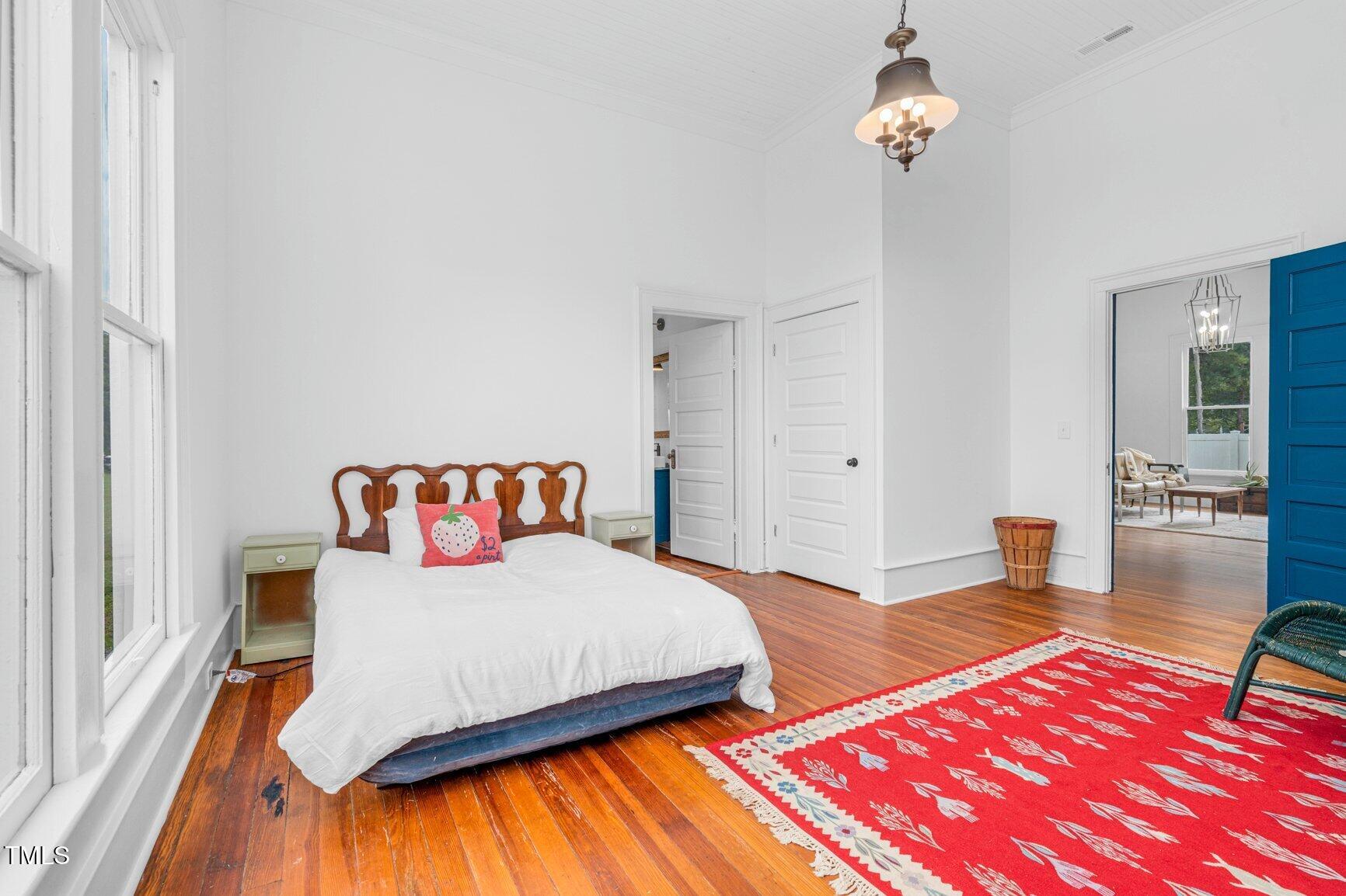 206 West Blalock Road Lucama, NC 27851 - Photo 31 of 35 a bedroom with a bed and wooden floor