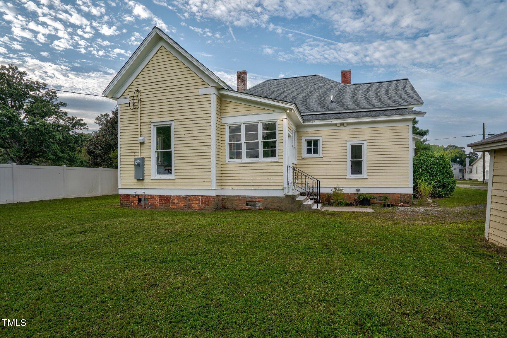 206 West Blalock Road Lucama, NC 27851 - Photo 32 of 35 a front view of a house with a garden