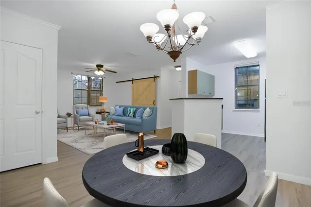 a living room with kitchen island furniture and a chandelier