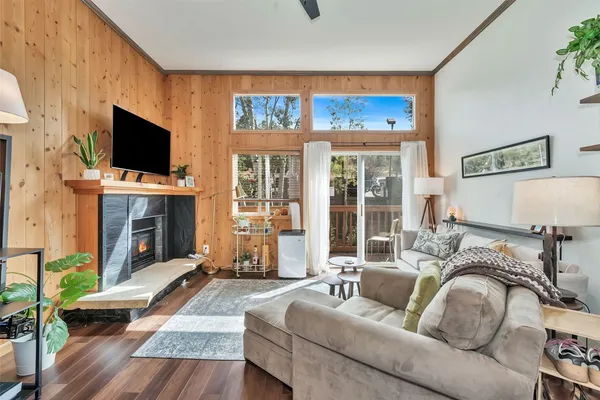 a living room with furniture a flat screen tv and a fireplace
