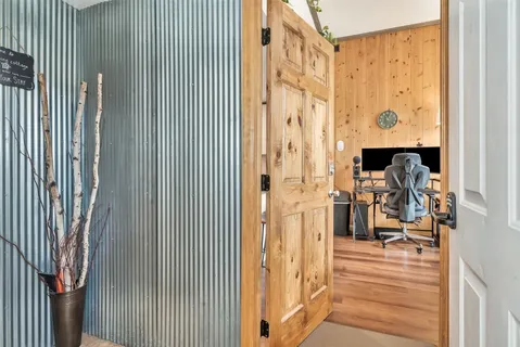 a view of a balcony with wooden floor and chair