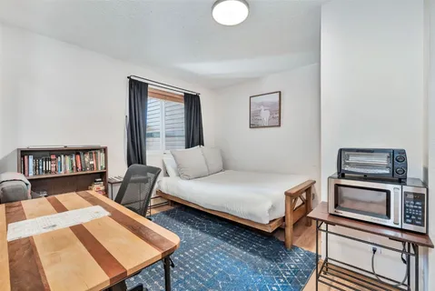 a bed room with a bed and a book shelf