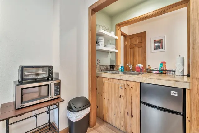 a bathroom with a granite countertop sink a toilet and a mirror