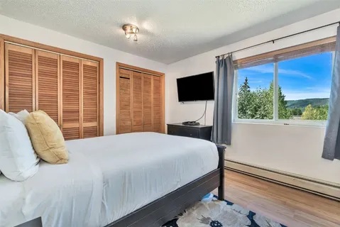 a bedroom with a large bed and a large window