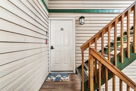 a view of entryway with wooden floor and stairs