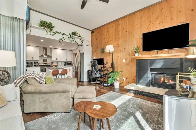 a living room with fireplace furniture and a flat screen tv