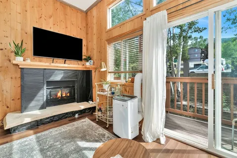 a living room with a fireplace and a flat screen tv