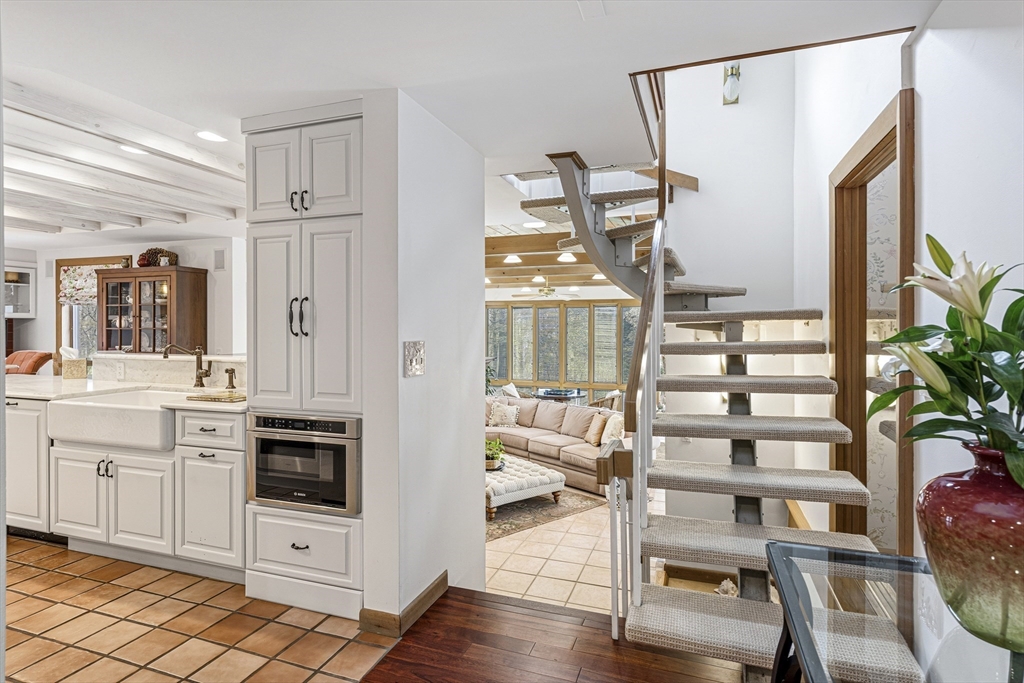 94 Howland Road Westport, MA 02790 - Photo 12 of 33 a kitchen with cabinets and wooden floor